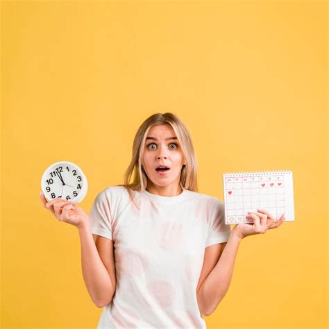 Woman Being Surprised And Holding A Clock And A Menstrual Calendar