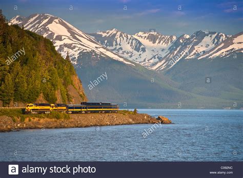 An Alaska Railroad Passenger Train Rounds A Corner Along Turnagain Arm