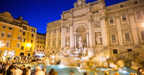 The Famous Trevi Fountain In Rome Italy Surrounded By A Large Crowd Of