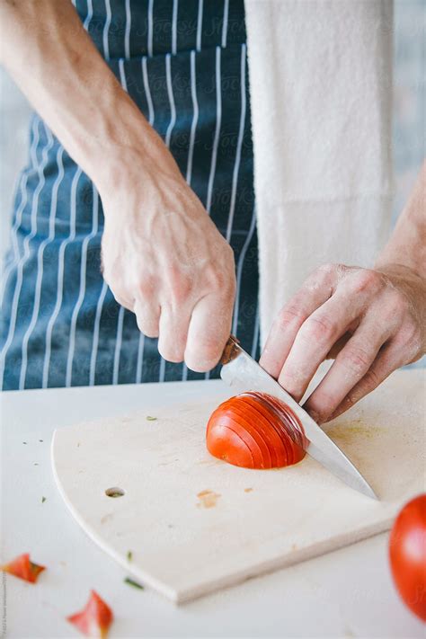 Chef Cuts Tomatoes By Stocksy Contributor Danil Nevsky Stocksy