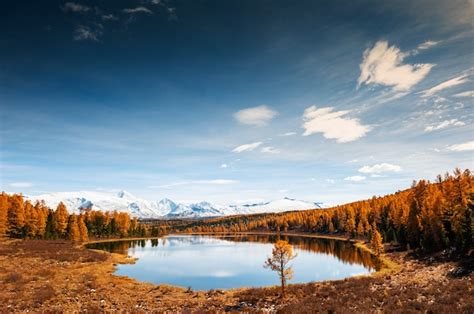 Premium Photo Kidelu Lake Snow Covered Mountains And Autumn Forest