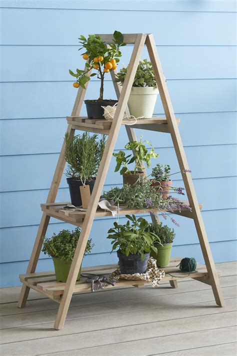 A wooden ladder is the perfect country chic accent to showcase your flowers, herbs and other plants in a rustic fashion. Next Wooden Ladder Planter - Natural | Wooden plant stands ...