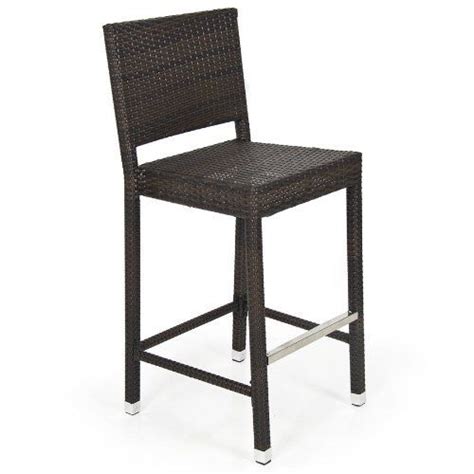 A Brown Wicker Bar Stool Sitting On Top Of A White Floor