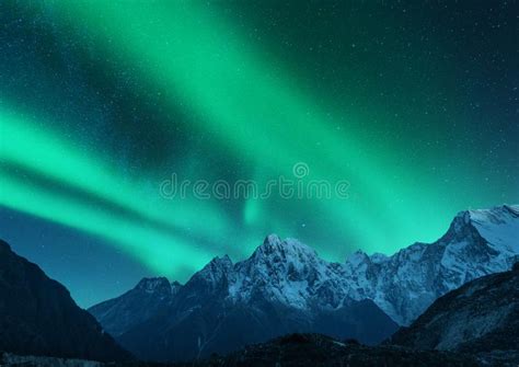 Aurora Borealis Above Snow Covered Mountain Range In