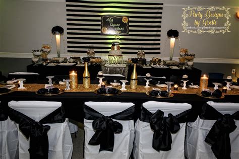 A Table With Black And White Chairs Covered In Gold Sequins Is Set Up