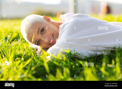 Millenial Young Woman Blonde Short Hair Outdoor Smiling Lay On Grass