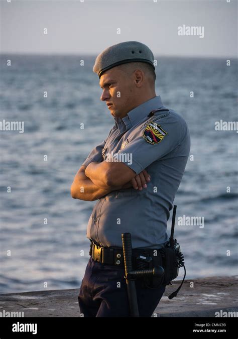 A Cuban Policeman A Member Of The Policia Especializada Stands With