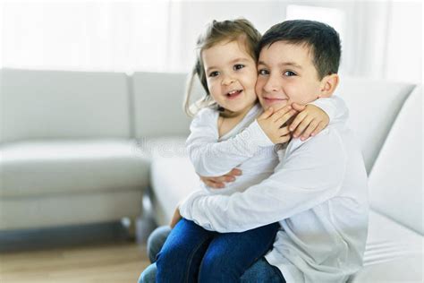 Brother And Sister Having Fun On The Sofa At Home Stock Image Image