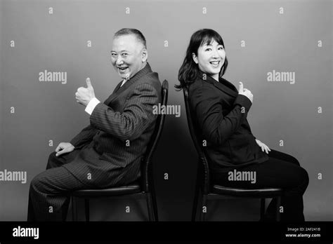 Mature Asian Businessman And Mature Asian Businesswoman Together Stock