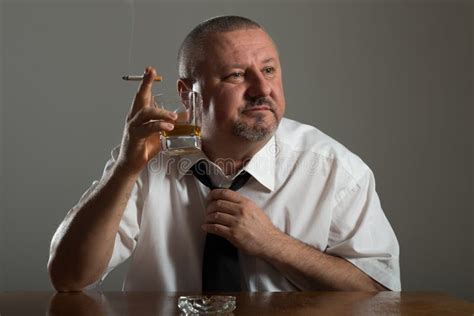 Businessman Drinking Alcohol And Smoking Cigarette Stock Photo Image