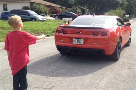 Watch Dad Pull Sons Tooth Out By Tying Him To A Muscle Car World