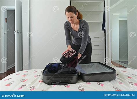 Woman Packing Suitcase In Bedroom Stock Image Image Of Businesswoman Door 203168695