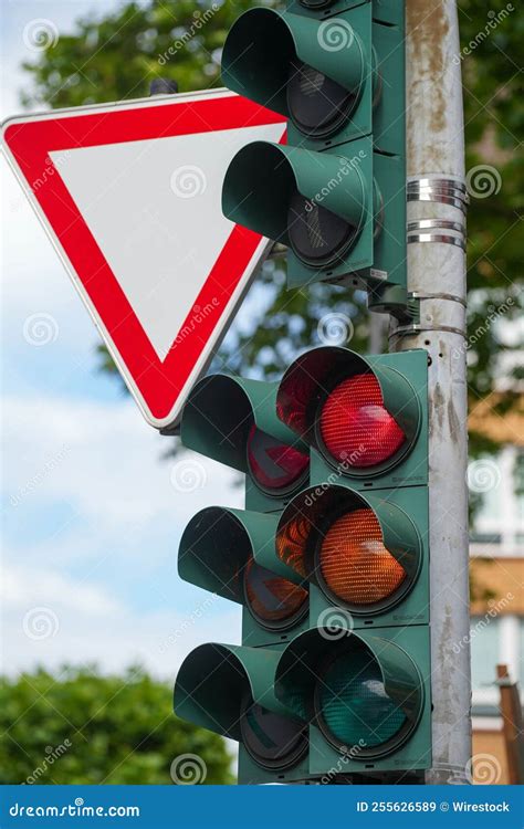 Vertical Closeup Shot Of A Traffic Light Showing A Red Stoplight And An