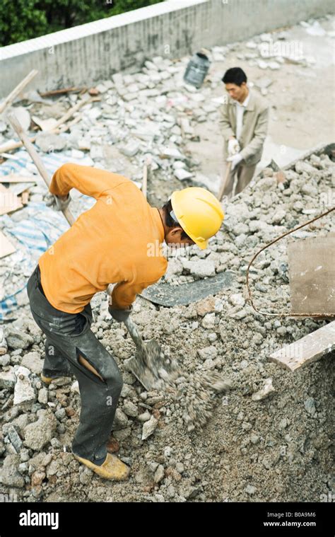 Construction Worker Digging At Construction Site High Angle View Stock