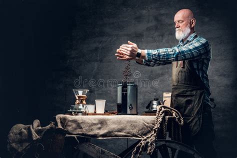 Old Man Barman Filling Coffee Machine With Coffee Beans Stock Image
