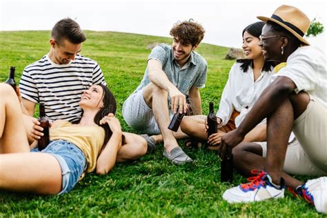 Group Of Multiracial Friends Hanging Out And Talking Outdoors In Public