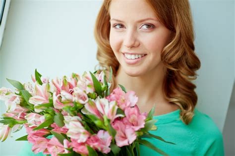 Free Photo Close Up Of Smiling Woman Holding A Bouquet