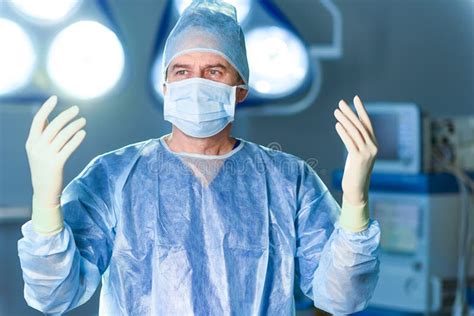 Serious Doctor Dressed In Surgical Uniform Stock Photo Image Of Care