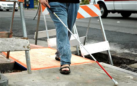 Blind Person Navigating Sidewalk Under Construction Szs Engineering