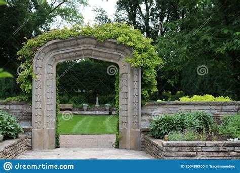 The Stone Arch Entry Covered In A Vine Leading To The Sunken Garden