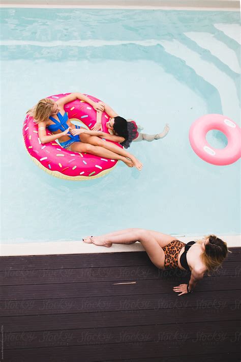 Friends Enjoying Time Together Outdoors In Swimming Pool By Stocksy