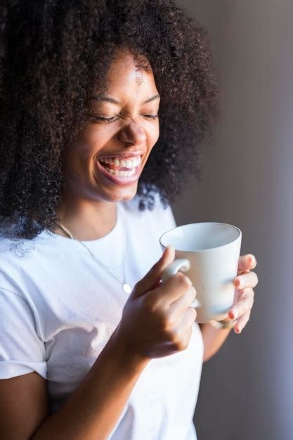 Premium Photo Laughing Woman Holding Cup Of Coffee