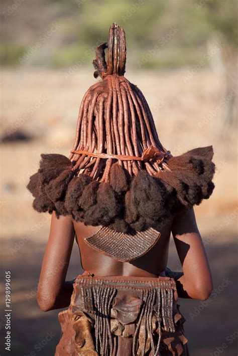 Rear View Of Young Himba Woman Showing Traditional Leather Clothing And