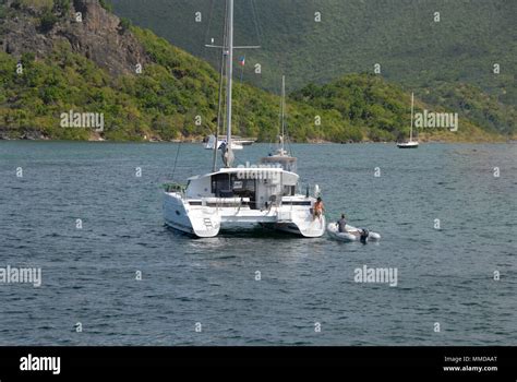 Young Couple Launchingrecovering Inflatable Dingy From Catamaran