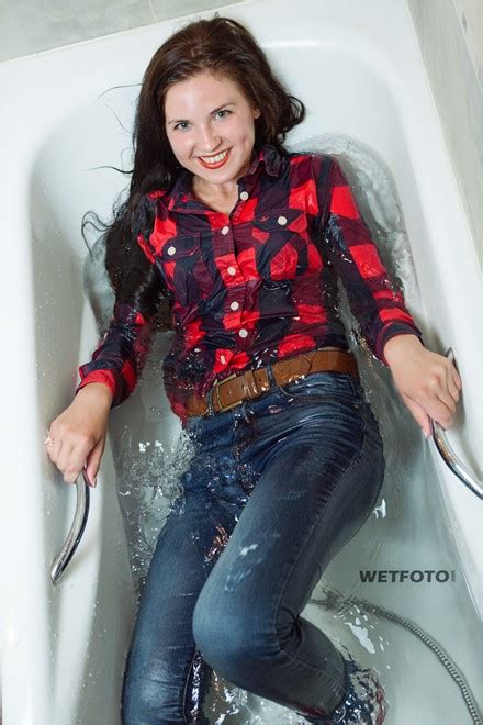 wetlook by happy brunette girl in bright shirt tight jeans and red socks in bath wetlook one