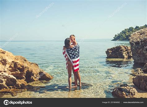 American Flag In Water With Sexy Woman And Man Independence Day Summer Holidays And Travel