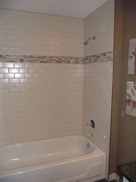 If you have tile or drywall above your fiberglass surround remove it with a hammer. Main bathroom - White subway tile tub surround, offset ...