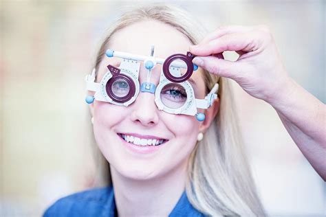 Optometrist Examining Womans Vision Photograph By Science Photo