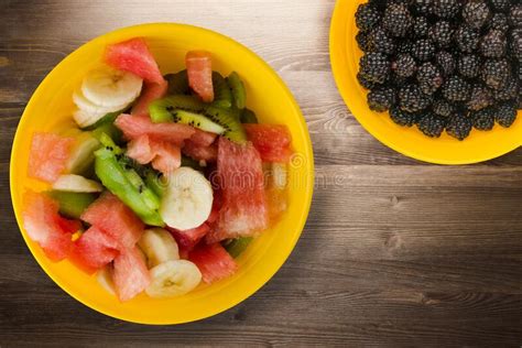 Plate Of Healthy Fresh Fruit Salad On Wooden Background Stock Photo