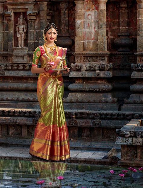a beautiful south indian bride wearing a kanchipuram silk saree and she is stand… bridal