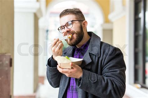 Fast Food And Meal Concept Young Man Eating Take Away Food On The