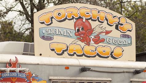 Manolis ice cream, pastries, & cakes. Torchy's Tacos sign at the Food Truck Trailer Park in ...