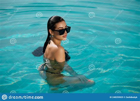 Glamorous Caucasian Woman In Sunglasses Relaxing Inside Swimming Pool Of Resort Stock Image