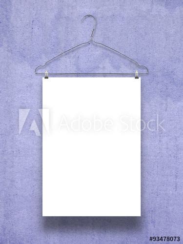 Single Hanged Paper Sheet With Clothes Hanger On Blue Concrete Wall