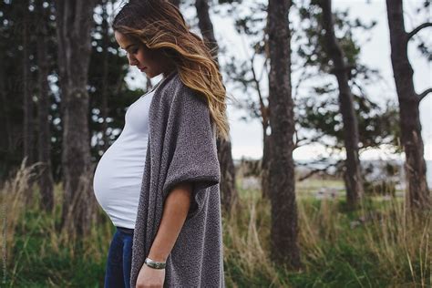 Beautiful Young Mixed Race Pregnant Woman Standing In Forest By Stocksy Contributor Rob And