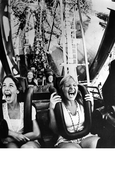 Two Women Laughing While Riding On A Roller Coaster