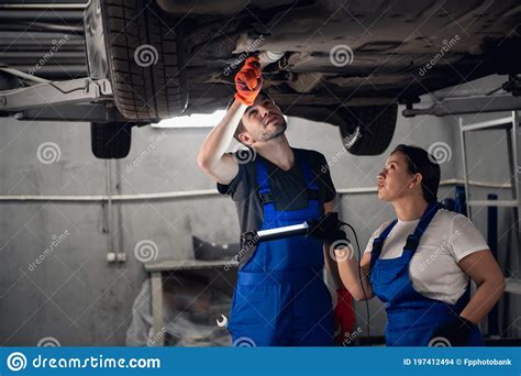 Workshop Worker And Mechanic Inspect Car With Torch Stock Photo Image