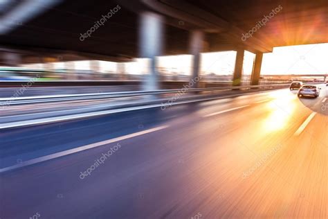 Car Driving On Freeway At Sunset Motion Blur — Stock Photo © 06photo