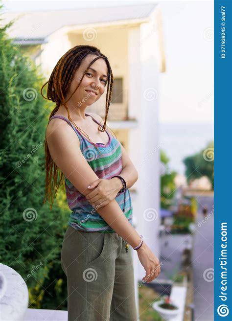 A Girl With A Dreadlocked Hairstyle Poses In The Summer Outdoor Stock