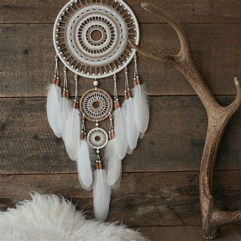 A Deer Antler Is Next To A White Dream Catcher