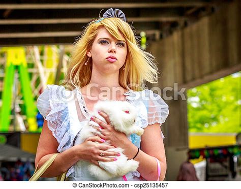 Alice In Wonderland Attractive Female Model In Alice Costume With