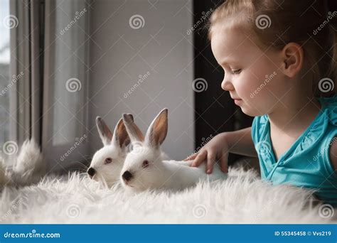 Cute Little Girl Playing With White Rabbits Stock Photo Image Of