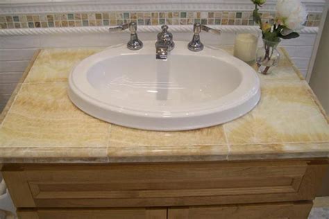 For areas that frequently get wet, tile is a practical choice. Tile Bathroom Countertops - Liberty Home Solutions, LLC