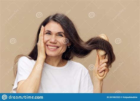 Beautiful Cute Attractive Middle Aged Brunette Combing Her Long Hair