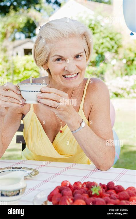 Mature Woman With Cup Of Tea Smiling Stock Photo Alamy