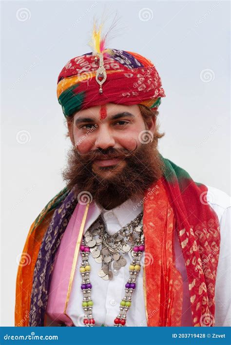 Rajasthani Handsome Man In Traditional Clothes Poses For A Photo During Camel Festival In